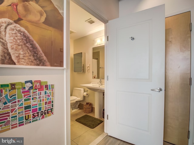 bathroom featuring toilet and tile patterned floors