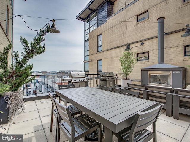 view of patio / terrace with area for grilling and a fireplace