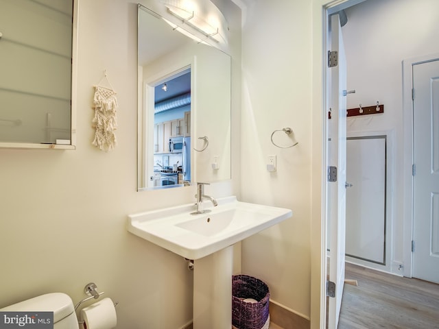 bathroom featuring hardwood / wood-style floors and toilet