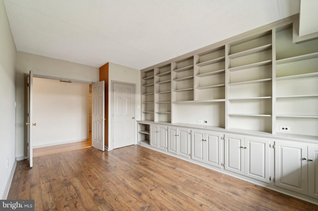 unfurnished living room featuring wood-type flooring