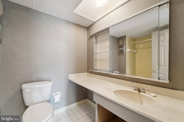 bathroom featuring walk in shower, vanity, and toilet