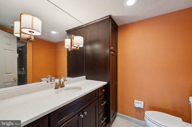 bathroom featuring walk in shower, vanity, toilet, and tile patterned floors