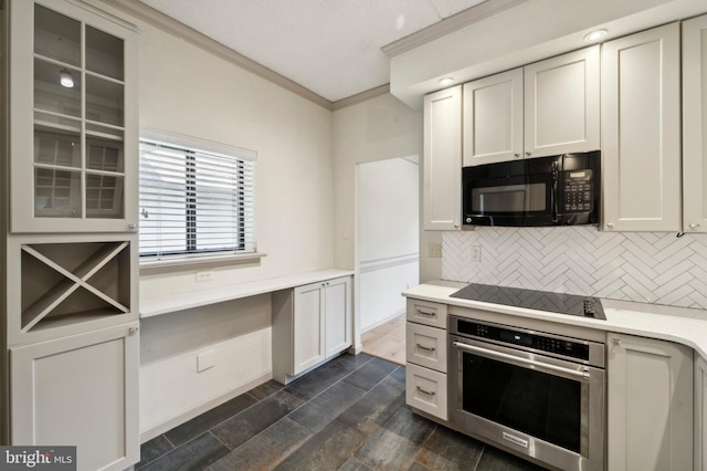 kitchen with black appliances, white cabinets, dark wood-type flooring, crown molding, and backsplash