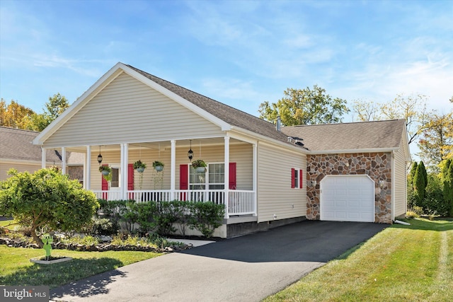 ranch-style house featuring a garage, a porch, and a front lawn