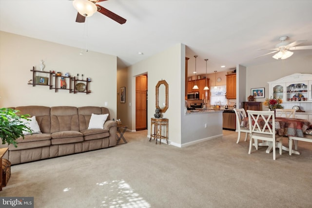 carpeted living room featuring ceiling fan