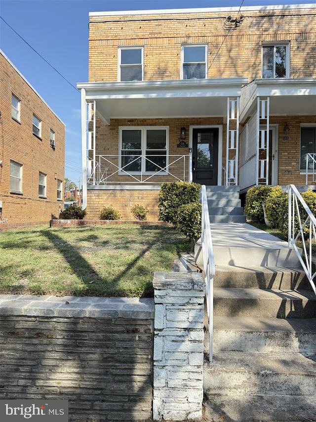 exterior space featuring a porch and a yard