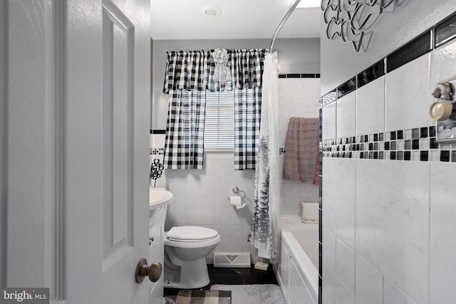 full bathroom with tile patterned floors, toilet, tile walls, and shower / tub combo