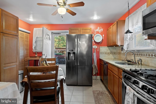 kitchen featuring stainless steel appliances, a healthy amount of sunlight, sink, and backsplash