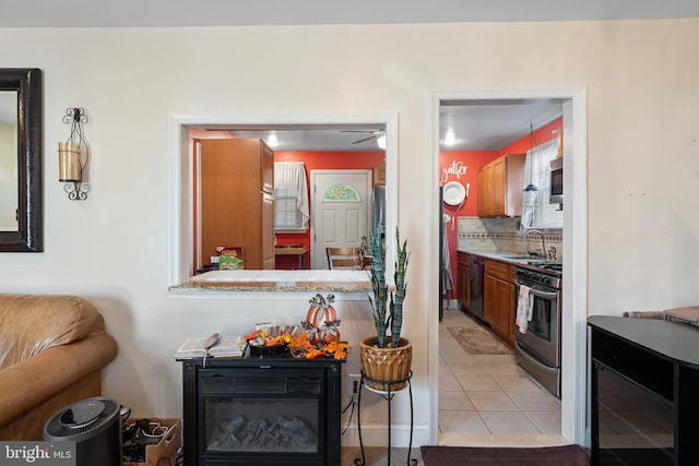 kitchen with sink, light tile patterned flooring, backsplash, appliances with stainless steel finishes, and wine cooler