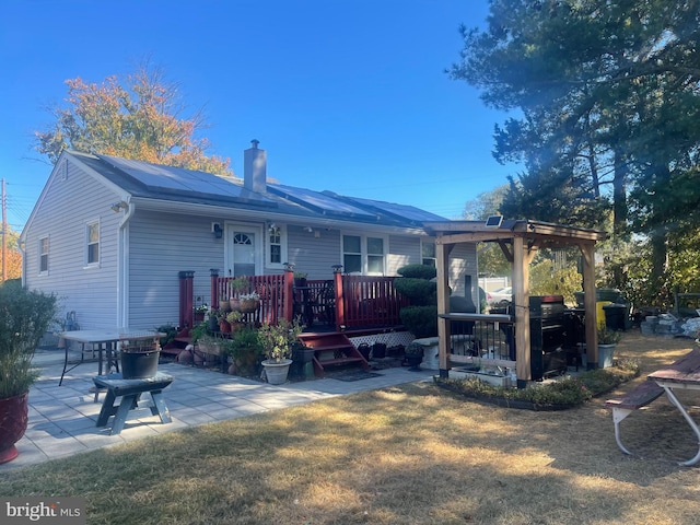 rear view of property with a pergola, a patio, a yard, and a deck