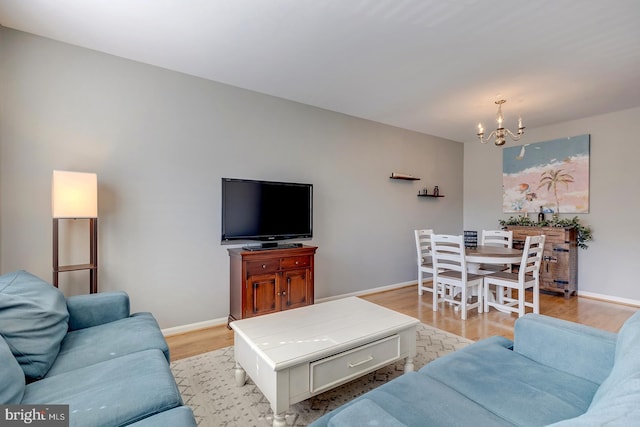 living room featuring an inviting chandelier and light wood-type flooring