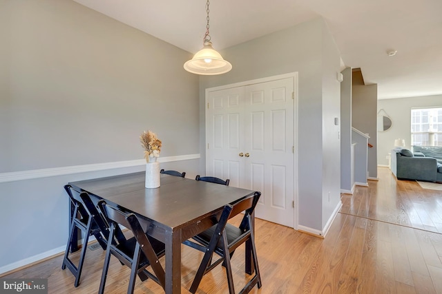 dining area featuring light wood-type flooring