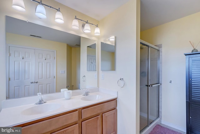 bathroom featuring vanity and an enclosed shower