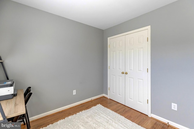 home office with hardwood / wood-style flooring