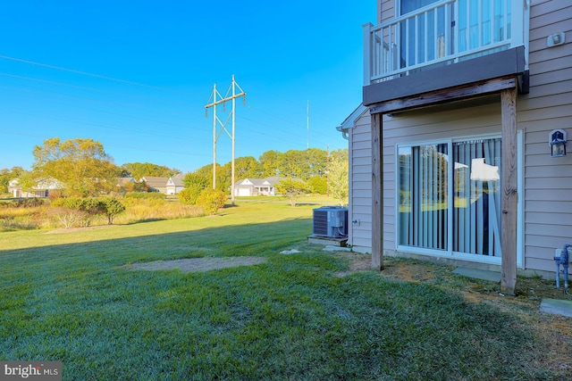 view of yard with a balcony and cooling unit