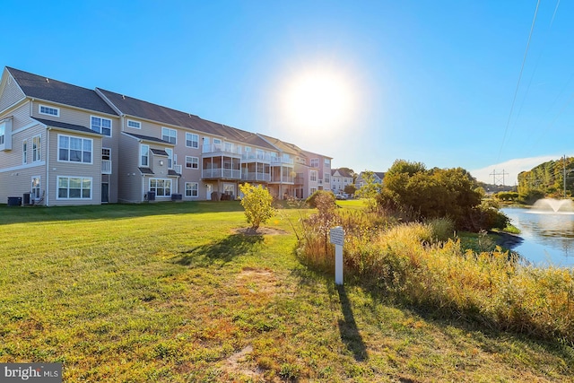 view of home's community featuring a yard and a water view