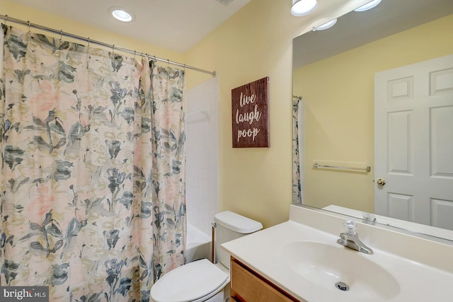 full bathroom featuring vanity, toilet, and shower / bath combination with curtain