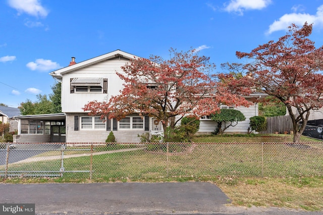 view of front of house with a front lawn and a carport