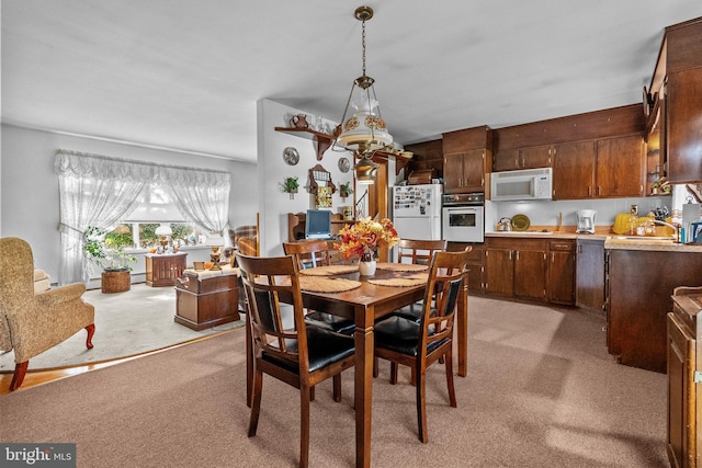 carpeted dining space with sink