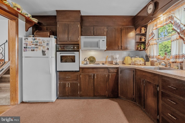 kitchen featuring dark brown cabinets, white appliances, sink, and tasteful backsplash