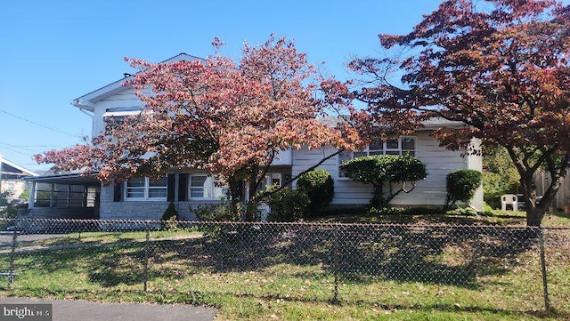 obstructed view of property featuring a front lawn