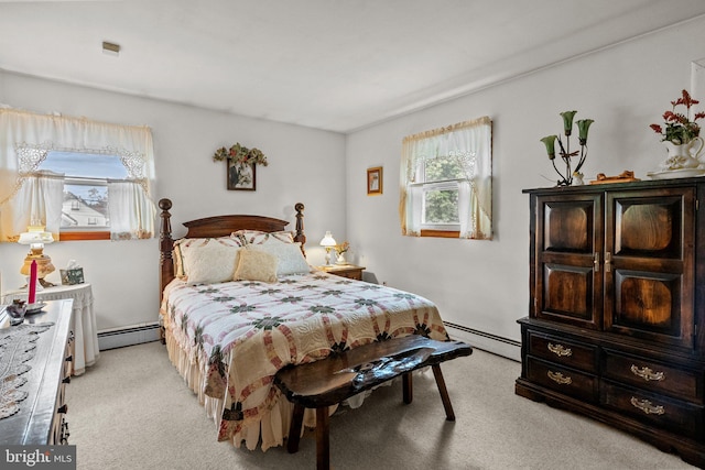 bedroom with a baseboard heating unit, light colored carpet, and multiple windows