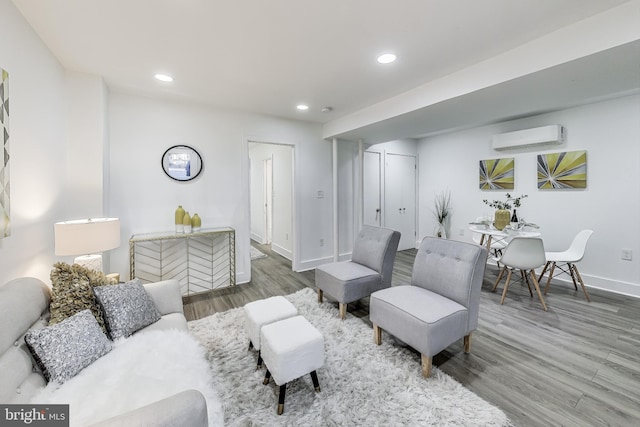 living room with hardwood / wood-style floors and a wall mounted AC