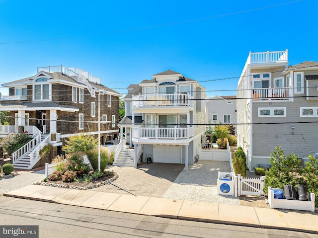 view of front of home featuring a balcony and a garage