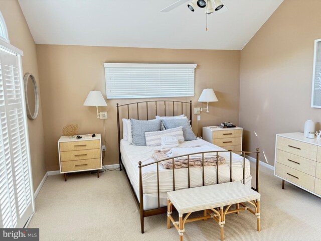 carpeted bedroom with ceiling fan and lofted ceiling