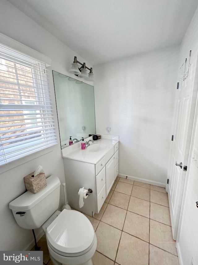 bathroom with tile patterned flooring, vanity, and toilet