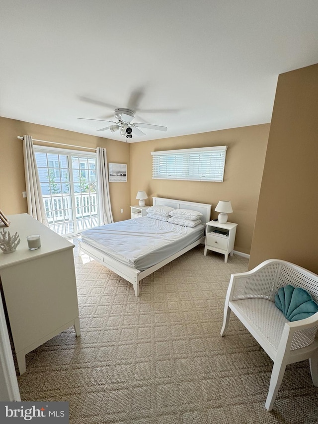 carpeted bedroom featuring access to outside and ceiling fan