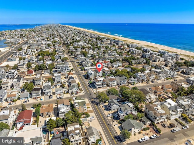 aerial view with a water view and a beach view