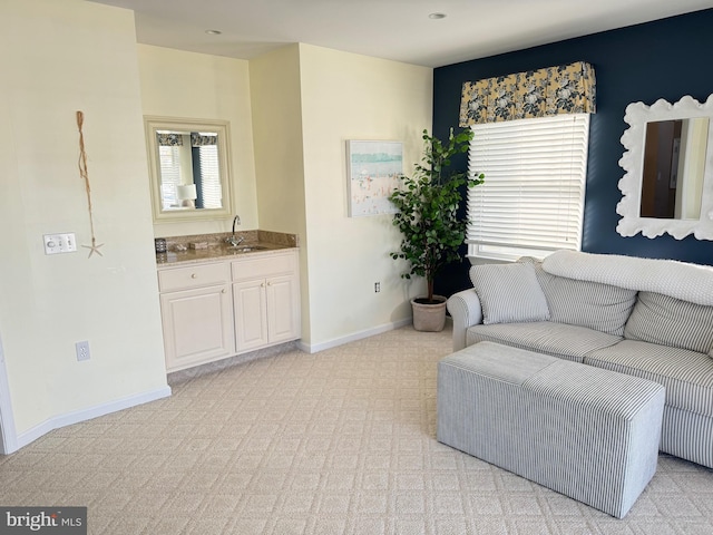 carpeted living room featuring sink