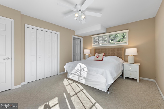 carpeted bedroom featuring ceiling fan and a closet