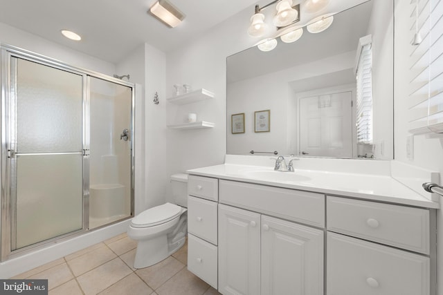 bathroom featuring tile patterned flooring, a shower with door, vanity, and toilet