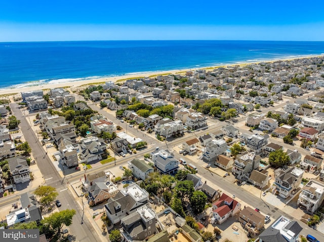 bird's eye view featuring a view of the beach and a water view