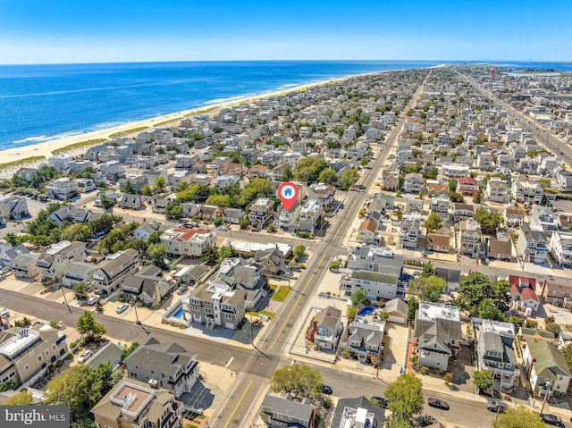 bird's eye view with a water view and a beach view