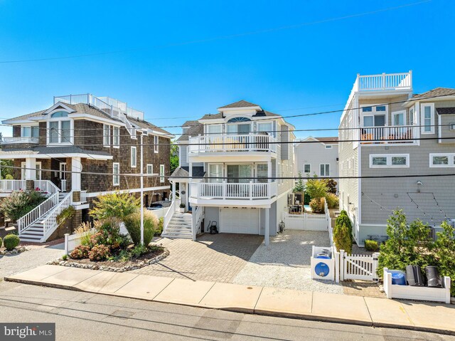 view of front of home featuring a garage and a balcony