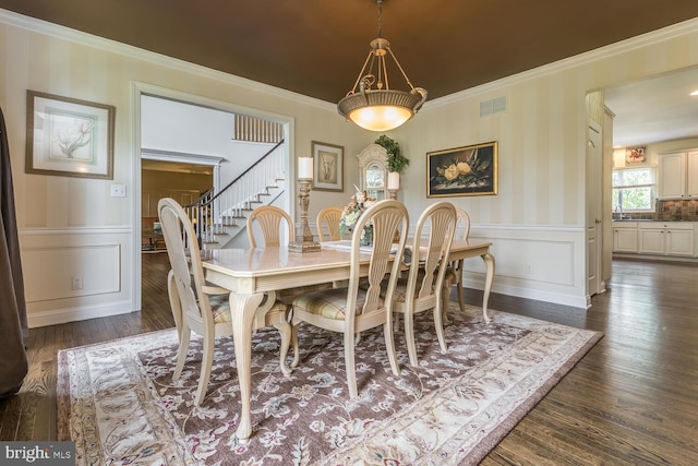 dining room featuring crown molding and dark hardwood / wood-style floors