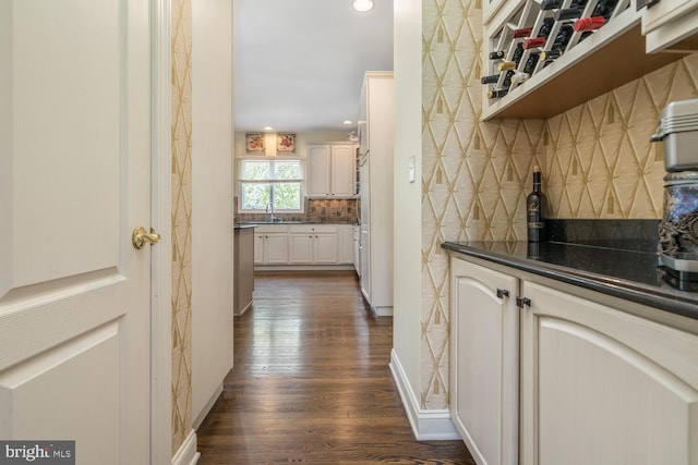 interior space with sink and dark wood-type flooring