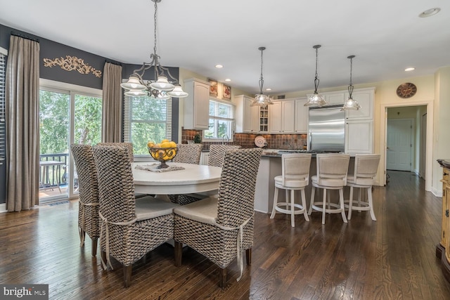 dining space with a healthy amount of sunlight and dark hardwood / wood-style floors