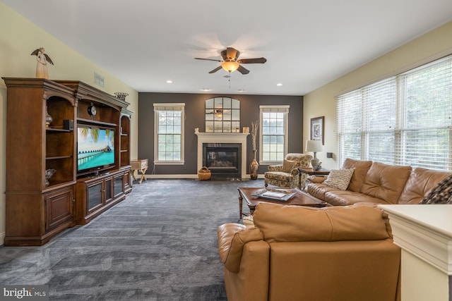 carpeted living room with ceiling fan