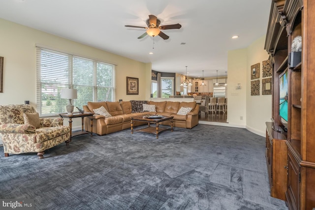 carpeted living room featuring ceiling fan