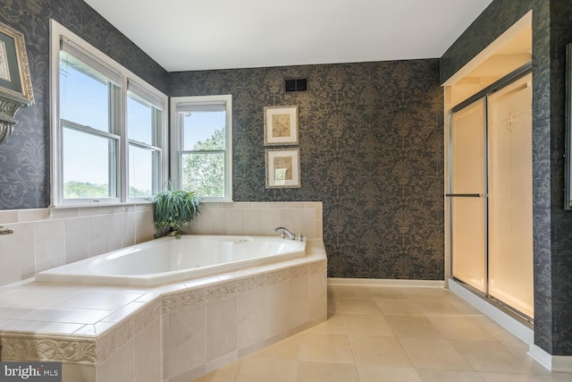 bathroom with tile patterned floors and independent shower and bath