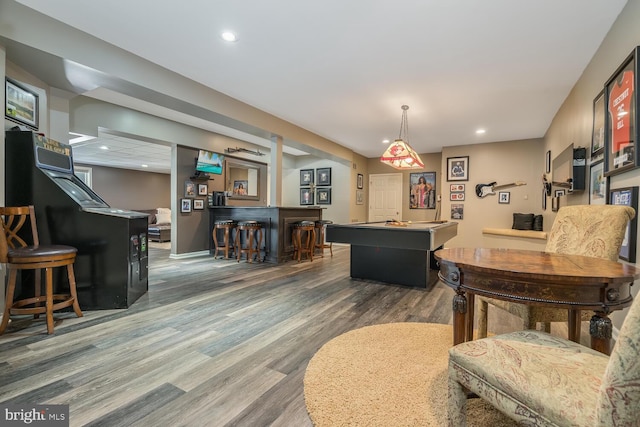 interior space with hardwood / wood-style flooring, pool table, and bar area