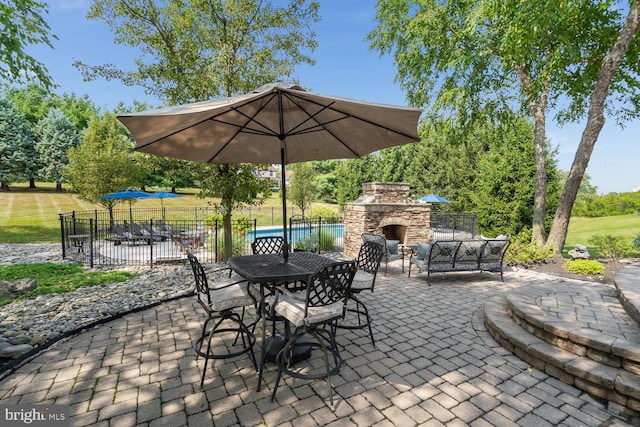 view of patio featuring an outdoor stone fireplace