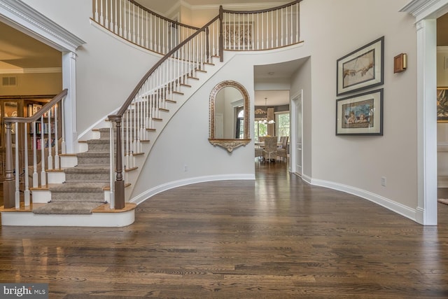 entrance foyer featuring dark hardwood / wood-style floors and crown molding