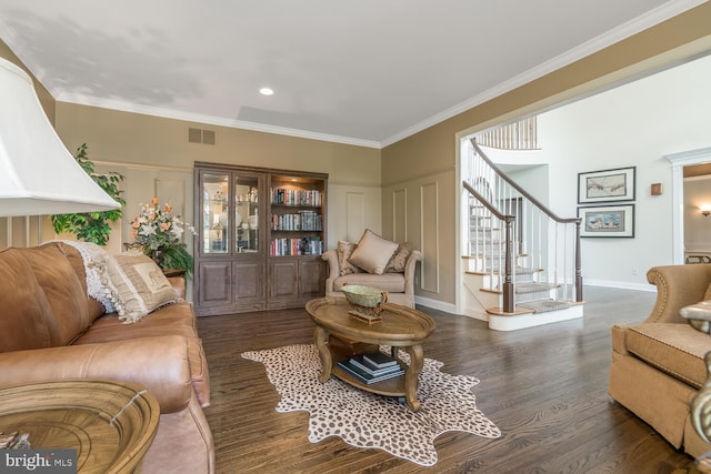 living room with dark hardwood / wood-style flooring and crown molding