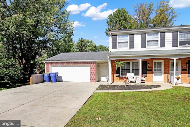 front facade with a garage, a front yard, and covered porch