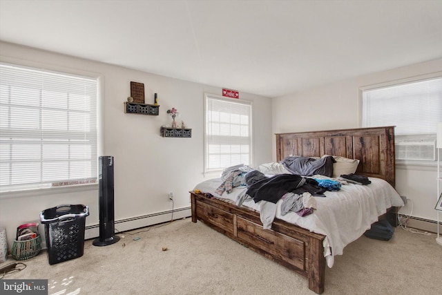 carpeted bedroom with cooling unit, multiple windows, and a baseboard radiator